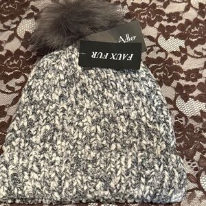 Marcus Adler women's knit beanie with a faux fur pom.